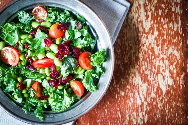 Kale and edamame salad on rustic background