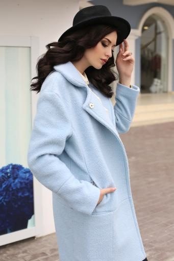 sensual woman with dark hair in elegant clothes and luxurious coat